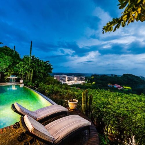 Experience the magical golden hour from the pool, with soft lighting illuminating your Tamarindo vacation rental.