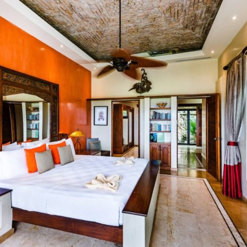 Elegant master bedroom with king-size bed, ideal for unwinding after a day exploring Tamarindo beach and town.