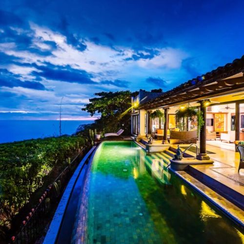 Relax by the pool as the sun sets over Tamarindo, creating a warm, inviting ambiance for your stay