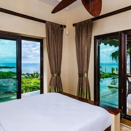 Cozy guest bedroom with a comfortable queen bed, perfect for relaxing after a day exploring Tamarindo beach.