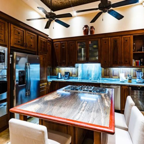 Bright and spacious kitchen with full amenities, ideal for families or groups enjoying a Tamarindo vacation rental experience.