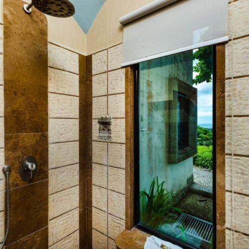 Enjoy the scenery while you freshen up—stand-up shower with a view in this stylish Tamarindo rental.