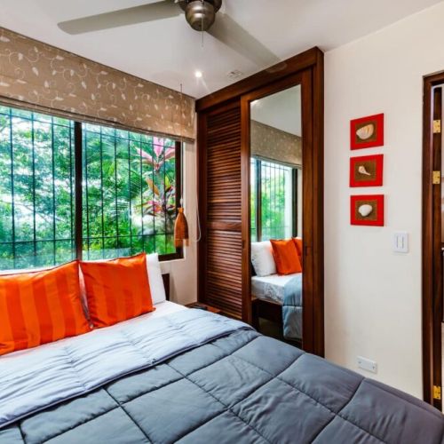Third bedroom with a queen bed, located beside the main house, featuring its own private kitchen for independent stays in Tamarindo.