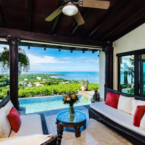 Chill on the outdoor terrace with a comfortable sofa and coffee table, enjoying the tropical ambiance of your Tamarindo getaway.