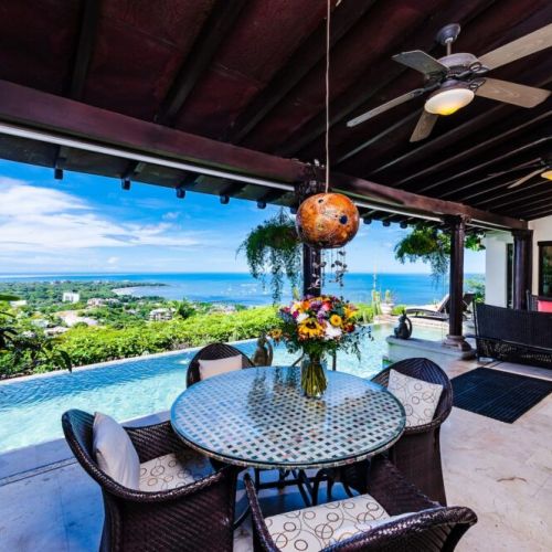 Stunning open terrace in Tamarindo, seamlessly connecting indoor and outdoor spaces. Perfect for relaxing, enjoying ocean breezes, and taking in breathtaking beach views at this vacation rental.